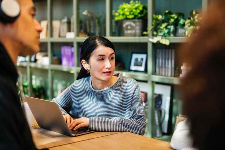 woman operating laptop on table